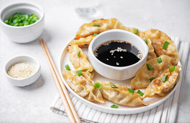 Dumplings with soy sauce in a plate