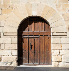 Fototapeta na wymiar old wooden door in stone house