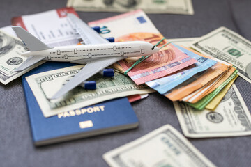 Fototapeta na wymiar Toy plane on Euro cash background, travel with airplane. Conceptual image of the price of airline tickets for travel. Selective focue, close-up.