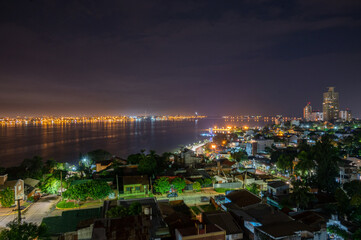 Obraz premium Dramatic night with many clouds in the city of Posadas, Argentina. Long exposure night photography.