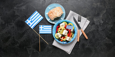 Flags of Greece with traditional salad and bread on dark background