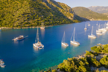 Aerial shot of luxury yachts anchored in laguna with crystal clear turquoise sea