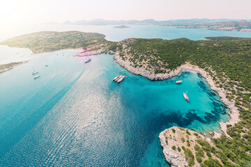 Aerial view of blue sea lagoon and yachts along the Aegean coast. Landscape of turkish riviera nature - obrazy, fototapety, plakaty