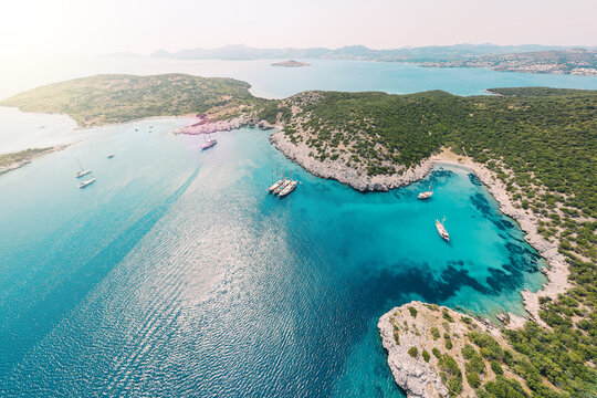 Aerial view of blue sea lagoon and yachts along the Aegean coast. Landscape of turkish riviera nature