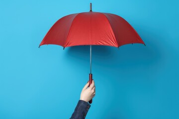 Hand holding red umbrella on blue background, Generative AI
