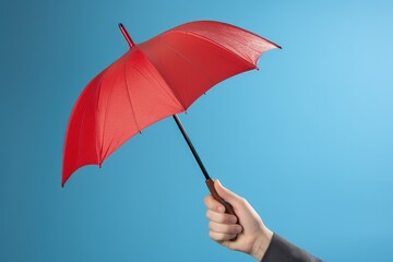 Hand holding red umbrella on blue background, Generative AI