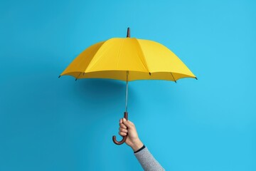 Hand holding yellow umbrella on blue background, Generative AI