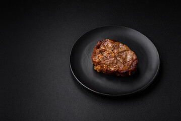 Delicious juicy pork or beef steak grilled with salt, spices and herbs
