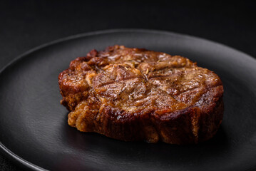 Delicious juicy pork or beef steak grilled with salt, spices and herbs