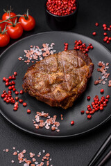 Delicious juicy pork or beef steak grilled with salt, spices and herbs