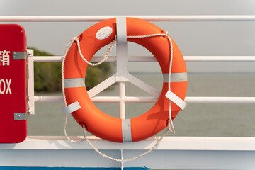 Lifebuoy hanging on a cement wall. Security concept