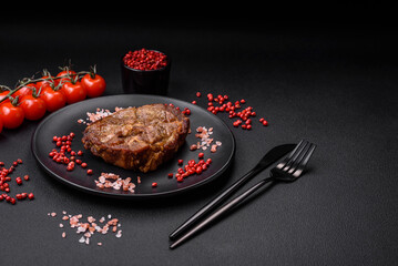 Delicious juicy pork or beef steak grilled with salt, spices and herbs
