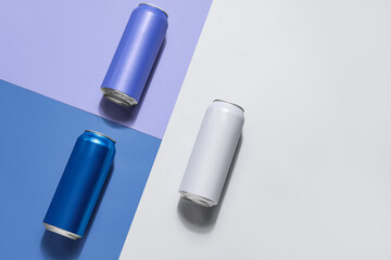 Cans of fresh soda on color background