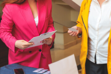 Process of checking in on a conference congress forum event, registration desk table, visitors and attendees receiving a name badge and entrance wristband bracelet and register electronic ticket
