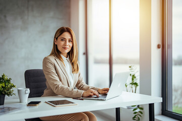 Close up portrait of smiling beautiful millennial businesswoman or CEO looking at camera, happy...