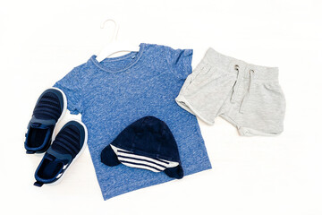 Summer babies blue clothes and accessories with t shirt, shorts,sneakers,panama. Modern fashion kids outfit. Set of children's clothing for spring or summer.Flat lay, top view,mockup