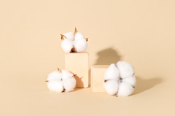 Cotton flowers and cubes on beige background