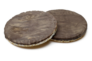 Dark chocolate covered round rice cake biscuits isolated on white background
