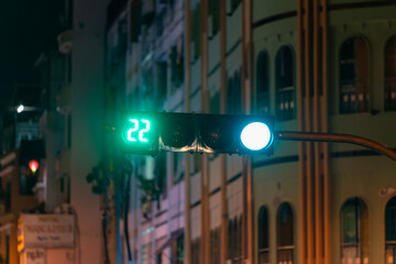 Green traffic light light up in city while night allows car to turn right