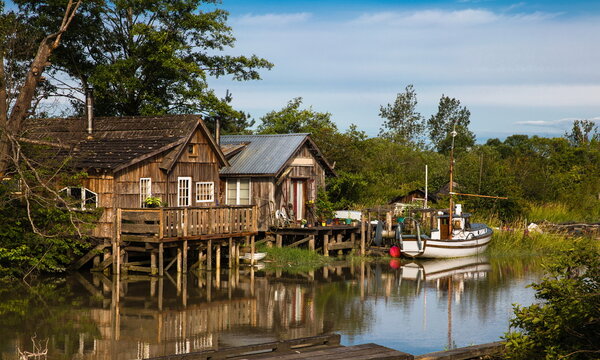 Finn Slough Panorama. Motorbot at Fishermen Village.  The historic fishing settlement of Finn Slough on the banks of the Fraser River in Richmond, British Columbia, Canada