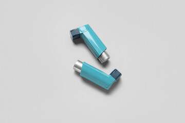Asthma inhalers on grey background