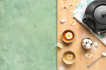 Wooden board with beautiful set for tea ceremony on green grunge background