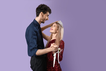 Beautiful prom couple on lilac background © Pixel-Shot