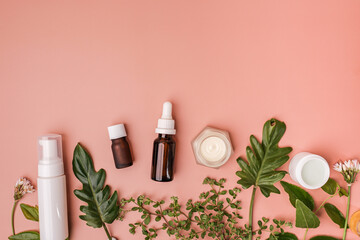 natural beauty, skincare, and cosmetic product with leaves and flowers on flat lay background with copy space for banner.