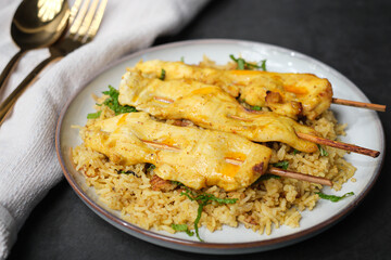 Chicken skewers over spice curry basmati rice.