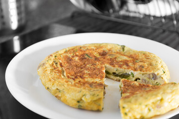 Vegetable omelette with peppers, green asparagus and mushrooms