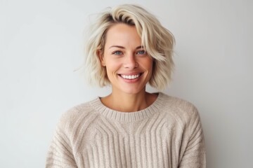 Fototapeta premium Medium shot portrait photography of a pleased woman in her 30s that is wearing a cozy sweater against a white background