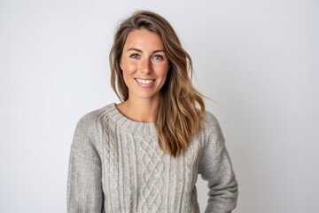 Portrait of a beautiful young woman in sweater smiling at camera.