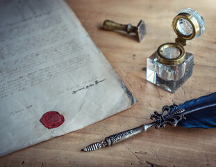 Old Fountain pen, quill pen, and old paper blank sheet and vintage inkwell on wooden desk in the...