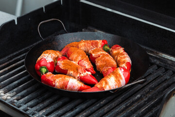 Paprika filled with cream cheese and bacon on a cast-iron frying pan / Cast iron pan / cast iron skillet /  Roasted Paprika / Paprika / Bacon / Grilled / BBQ 