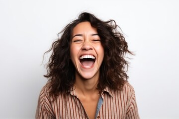 Portrait of a happy young woman laughing and screaming on white background