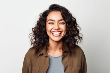 Obraz premium Portrait of a smiling young woman with curly hair on white background