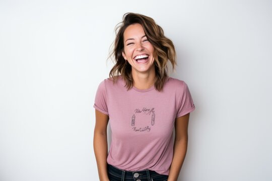 Lifestyle portrait photography of a pleased woman in her 30s that is wearing a fun graphic tee against a white background . Generative AI