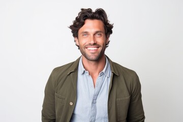 Portrait of a handsome man smiling and looking at camera over white background