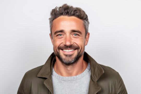 Portrait of a handsome man smiling at the camera on a white background