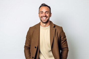 Fototapeta premium Portrait of a handsome young man smiling on a white background.