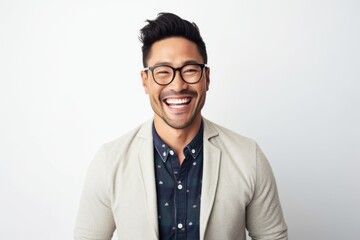 Portrait of happy asian man laughing and looking at camera over white background