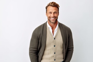 Portrait of a handsome young man smiling at the camera while standing against white background