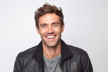Obraz premium Portrait of a smiling young man in leather jacket on white background