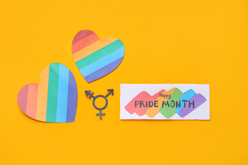 Card with text HAPPY PRIDE MONTH, transgender symbol and hearts on orange background
