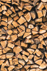 background of Heap firewood stack, natural wood / Firewood / textured firewood background of chopped wood for kindling and heating the house / a woodpile with stacked firewood