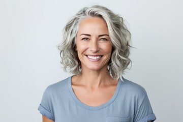 Fototapeta premium Portrait of happy mature woman looking at camera over white background.