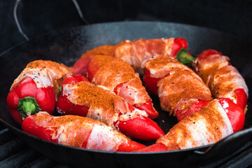 Paprika filled with cream cheese and bacon on a cast-iron frying pan / Cast iron pan / cast iron skillet /  Roasted Paprika / Paprika / Bacon / Grilled / BBQ 