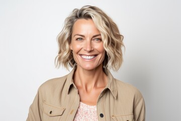 Portrait of a beautiful middle aged woman smiling at the camera over white background