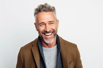 Fototapeta premium Portrait of a happy mature man smiling at camera over white background