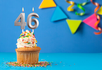 Birthday cake with candle number 46 - Blue background